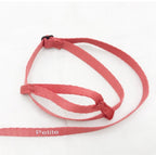 Salmon pink harness strap laid flat on white