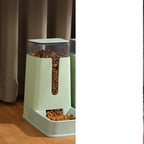 Green feeder with kibble filling the tray