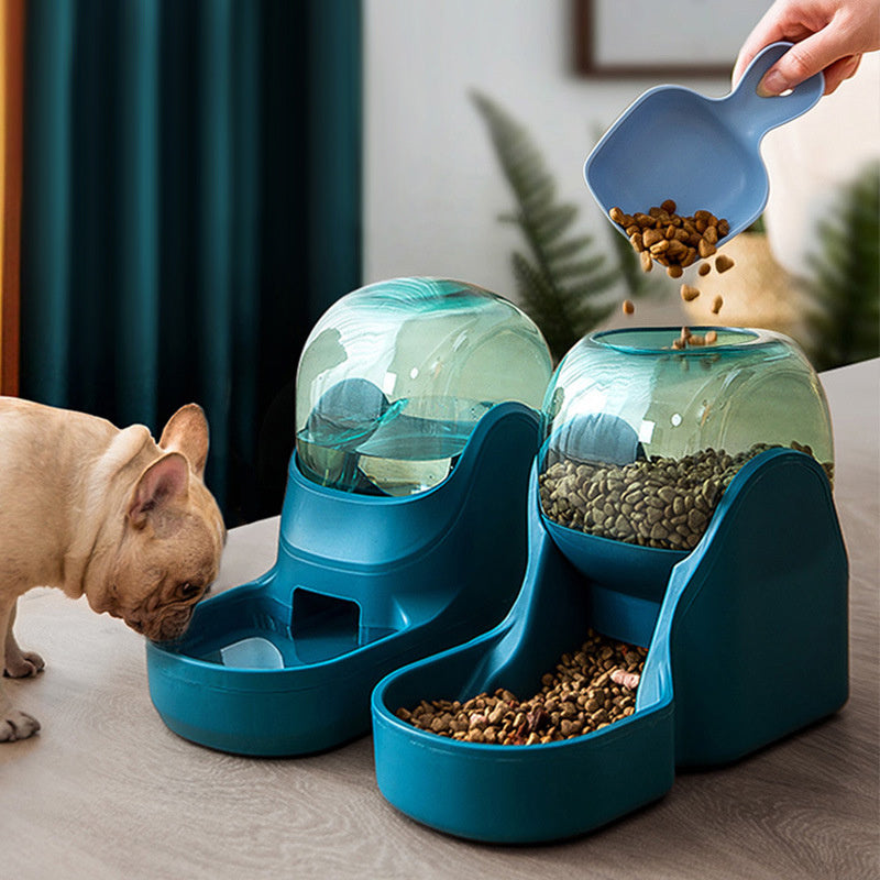 French bulldog eating from the teal feeder while kibble is poured