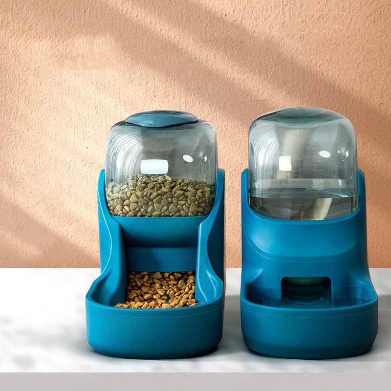 Teal feeder and waterer standing on a marble surface