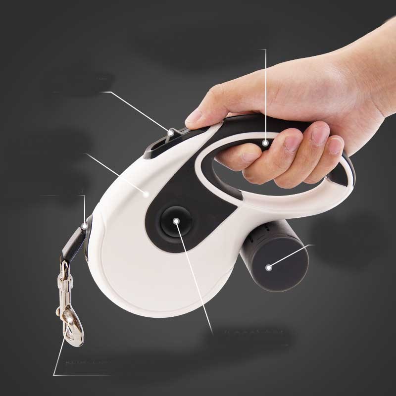 Hand gripping the white retractable leash housing, dark background