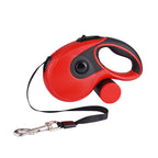 Red retractable leash with black strap extended