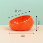 Orange slanted ceramic bowl, side view