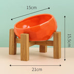 Orange bowl resting in its wooden stand