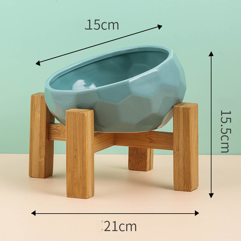 Teal bowl resting in its wooden stand