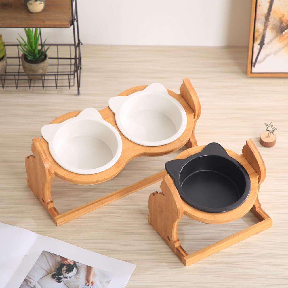 Two bowl stands on a wooden floor, one double and one single