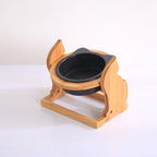 Single stand holding one black ceramic bowl