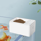 White feeder mounted on a tank rim with goldfish below