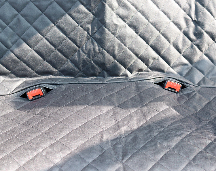 Close-up of the quilted grey fabric and seat belt openings