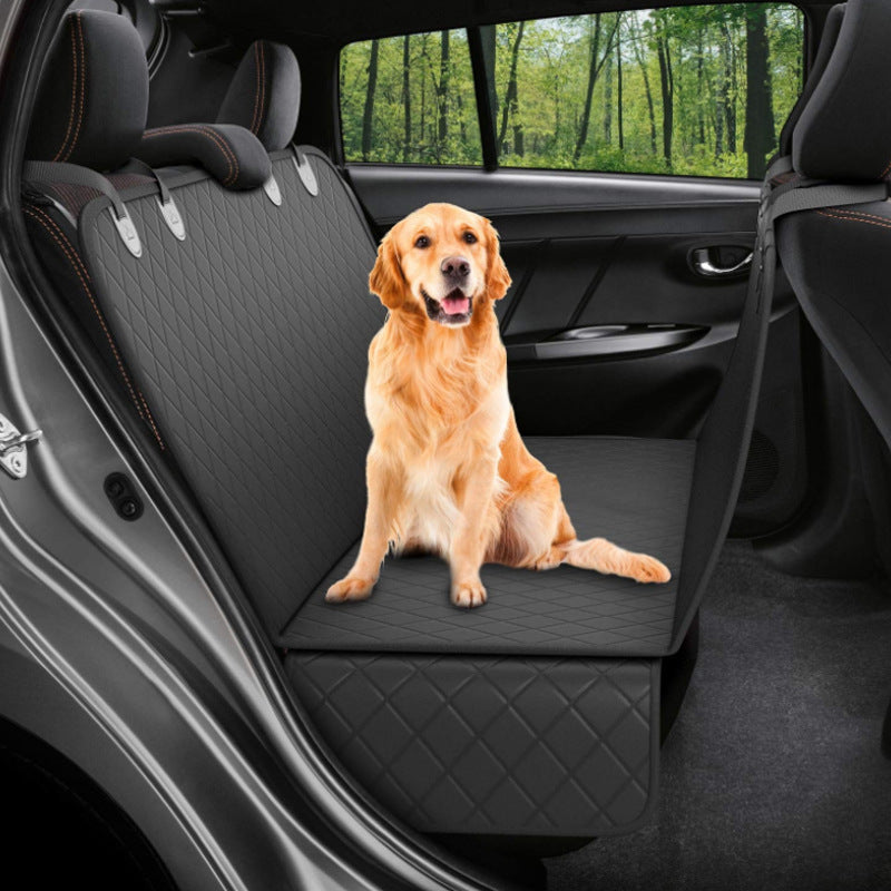 Golden retriever on the black hammock cover in a car
