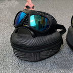 Blue lens goggles resting on the zipped carry case
