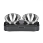 Two stainless steel bowls on a black tilted stand