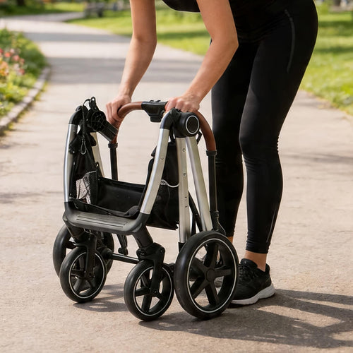 Person folding the stroller flat on a path