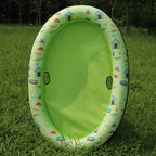 Green float with a printed rim standing upright on grass