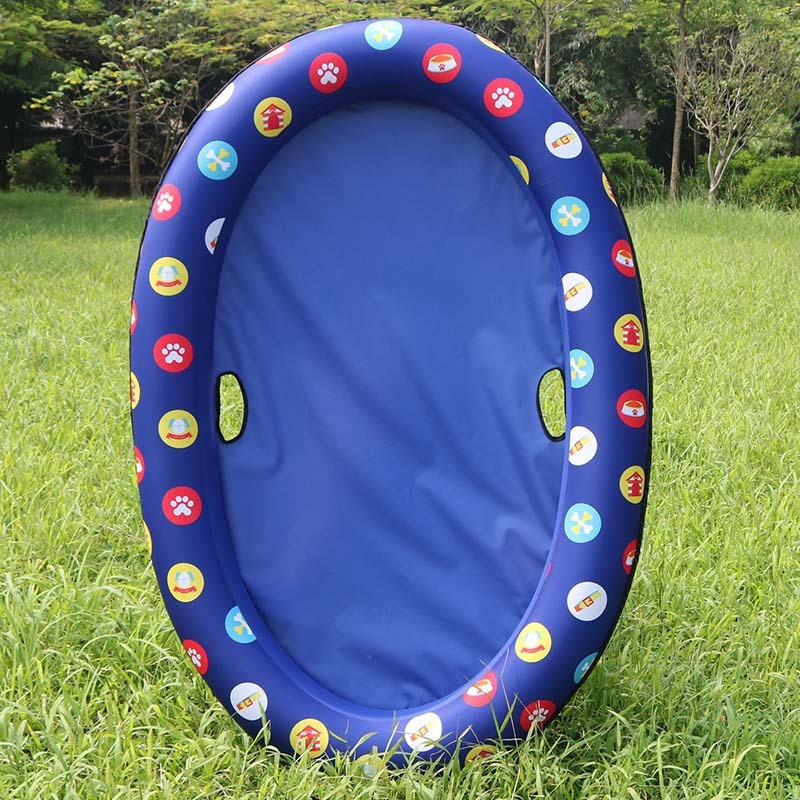 Blue float with a colourful patterned rim on grass