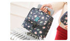 Person holding the navy floral version of the bag