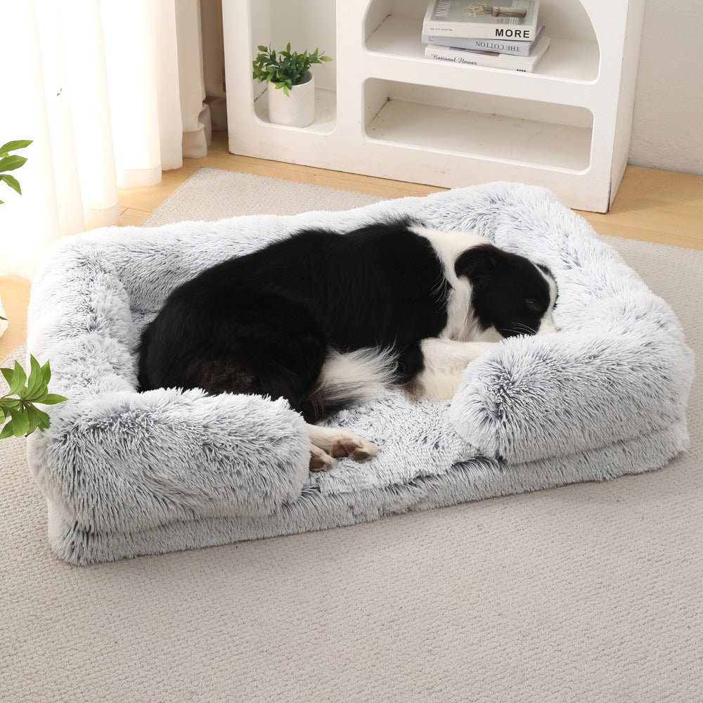 Border collie lying on the grey plush sofa bed