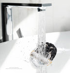 Clipper blade being rinsed under running water