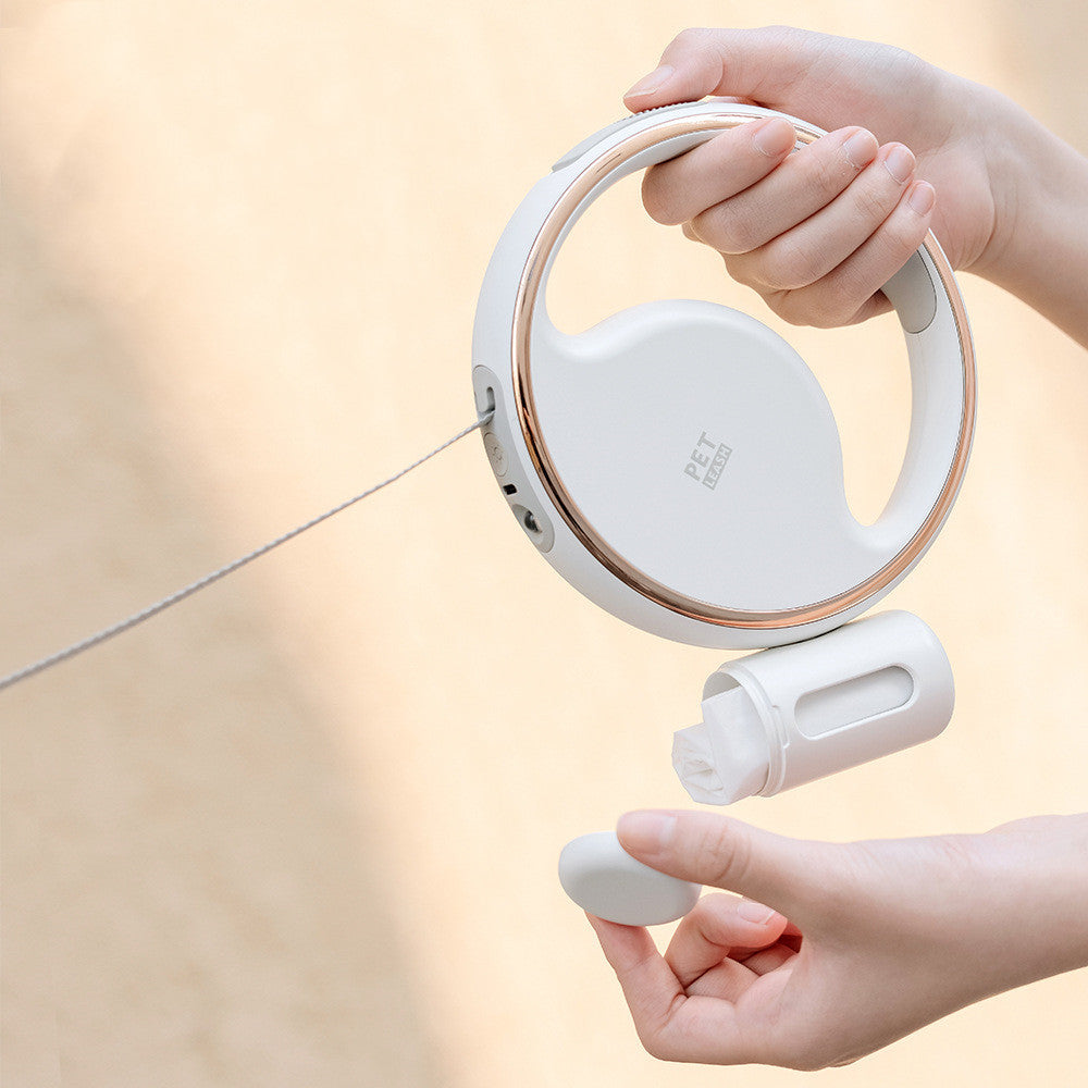 Hands holding the white ring leash with its bottle attachment