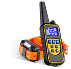 Transmitter beside an orange receiver collar with the light on