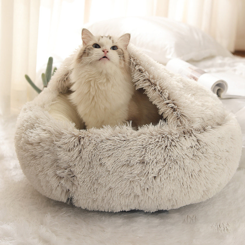 Grey plush shell nest with a ragdoll cat sitting up