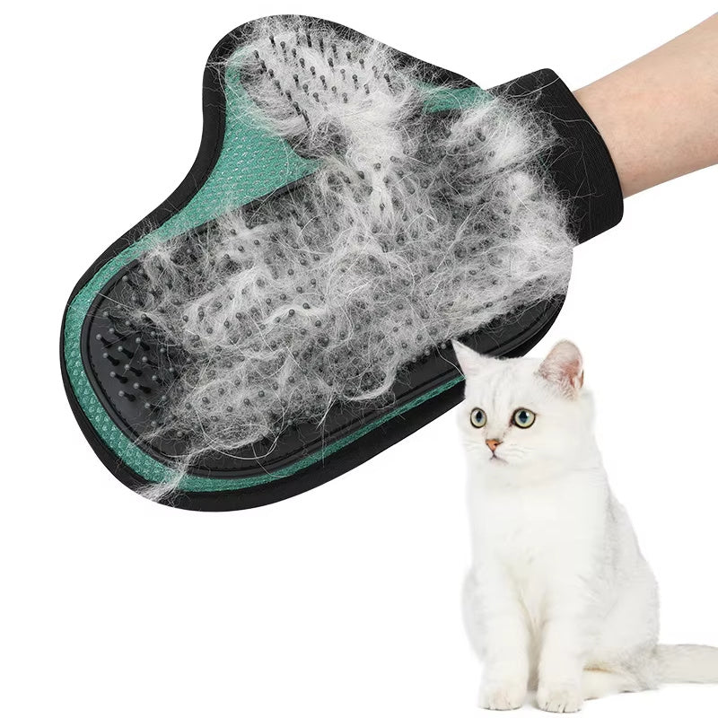 Hand in the green glove covered in loose fur, cat beside it