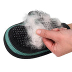 Hand pulling a clump of loose fur off the glove