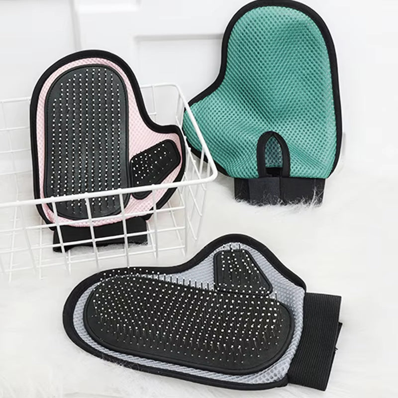 Three gloves in green, pink and grey on a drying rack