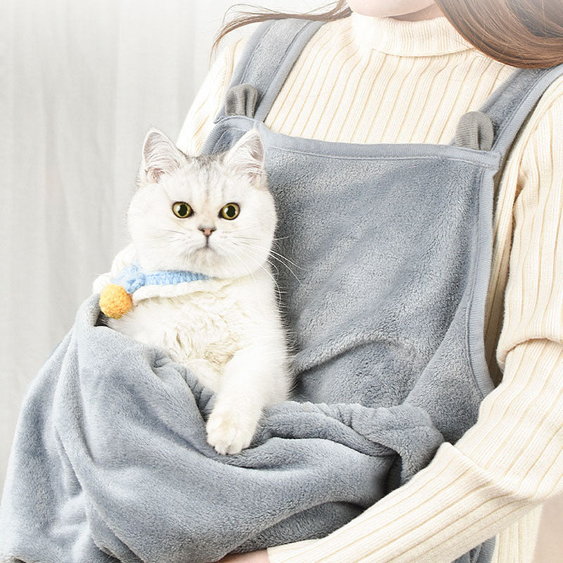 Person wearing the grey apron with a white cat in the pouch