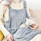 Person holding a cat resting inside the apron pouch