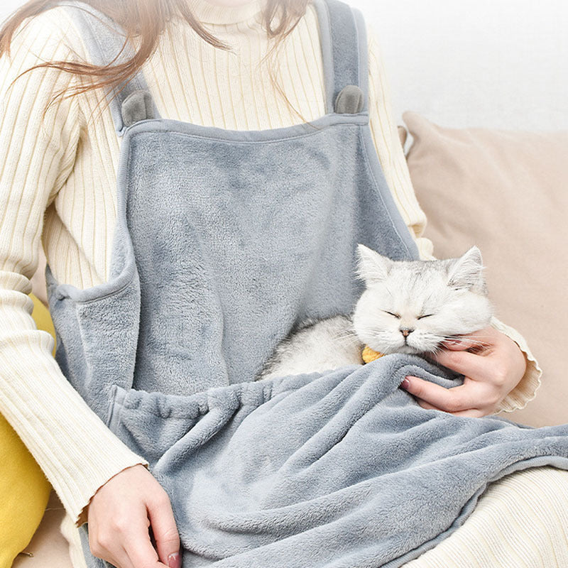 Person holding a cat resting inside the apron pouch