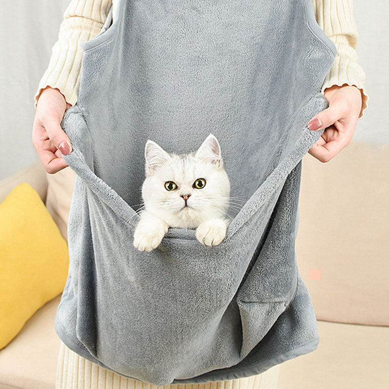 Cat peeking out of the apron's front pocket