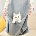 Cat peeking out of the apron's front pocket