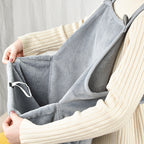 Hands opening the front pouch of the apron